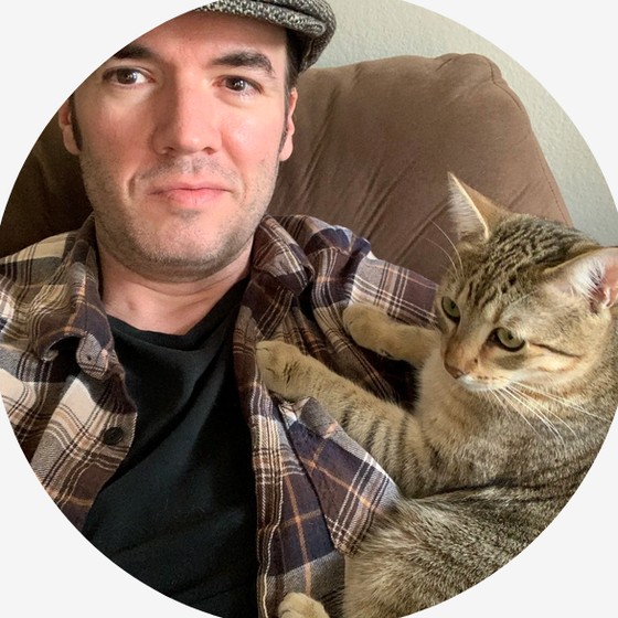 Matt Ballin, holding a cat.
